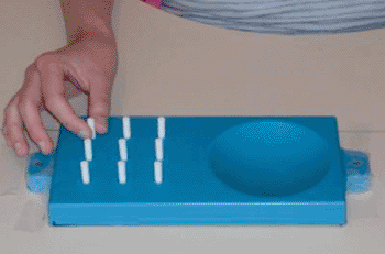 Image: The nine-peg test for manual dexterity (Photo courtesy of the University of Pittsburgh).